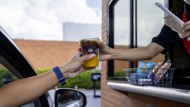 Server hands customer drink drive-thru