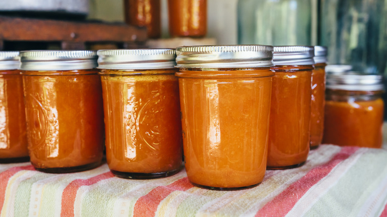 A table full of filled straight-sided Mason jars