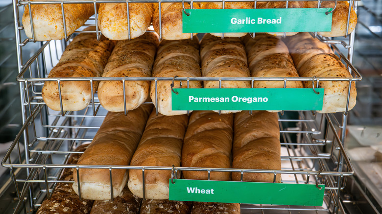 A rack filled with bread in a Subway store.