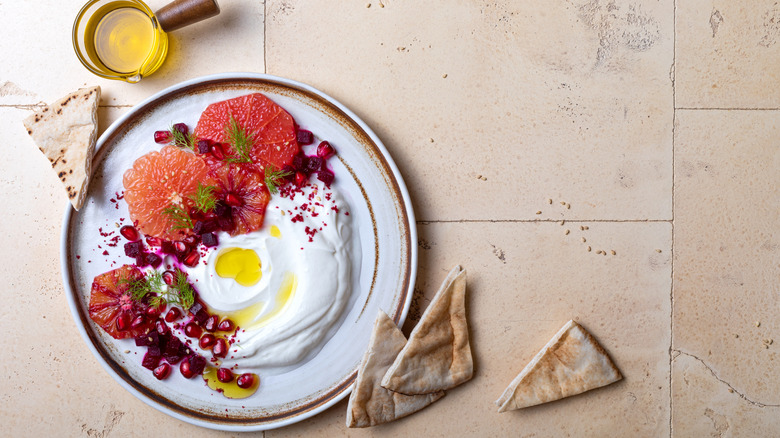 Sumac atop fruit and yogurt with pita