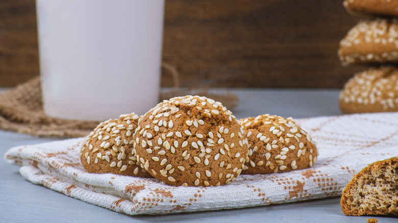 tahini cookies coated in sesame seeds lying on a cloth