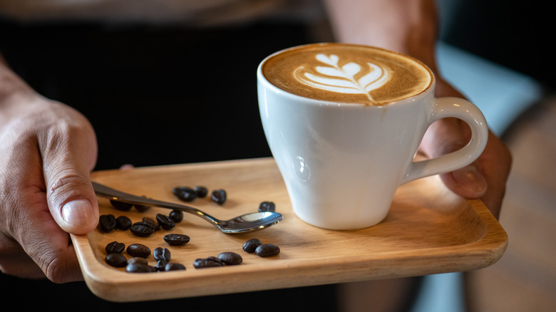 Mug with a latte and coffee beans