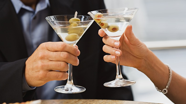 Hands toasting with vodka martinis