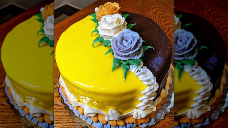 Half and Half Doberge cake with frosting roses on top