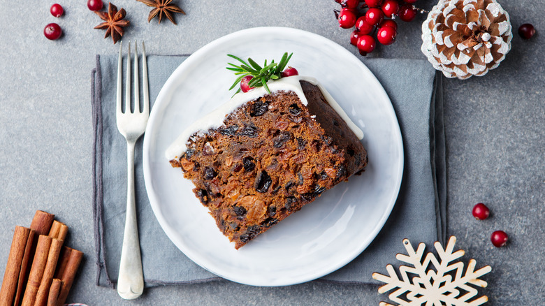 Slice of frosted fruitcake on a plate