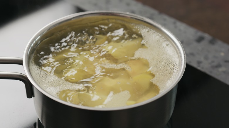Potatoes boiling in pot or water