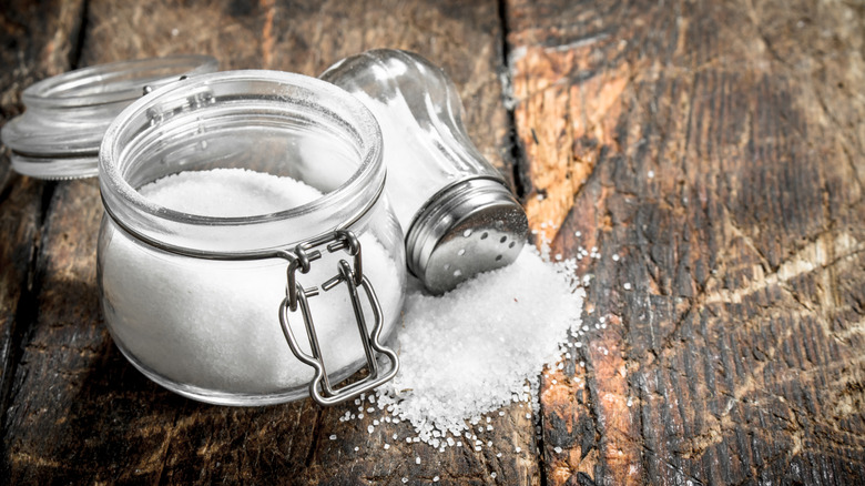 salt stored in glass jar with a salt shaker on the side