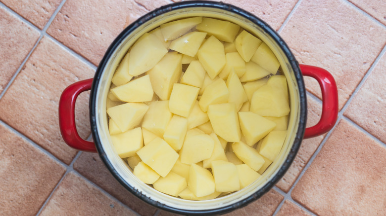 Peeled potatoes in a pot