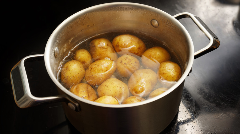 A metal pot full of potatoes