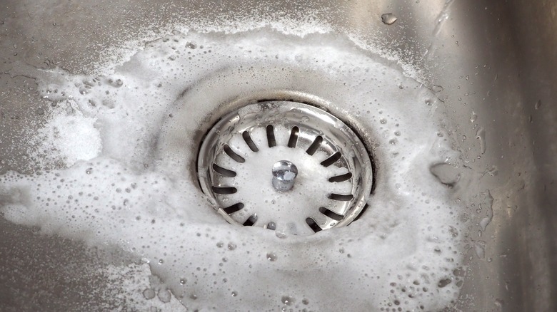 Cleaning sink with baking soda and vinegar