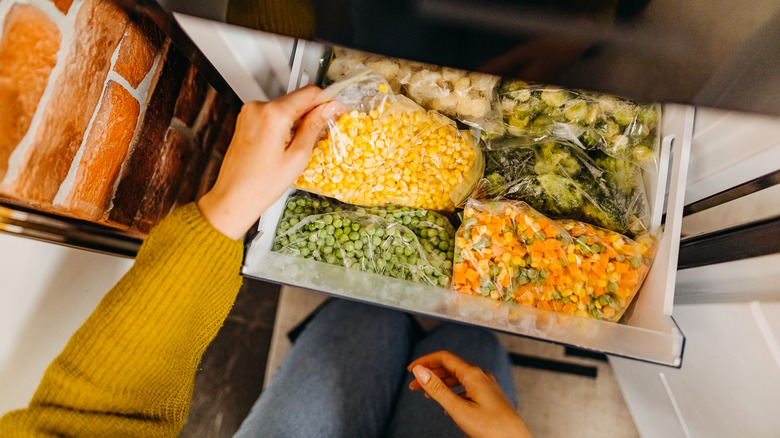 Taking frozen vegetables from freezer