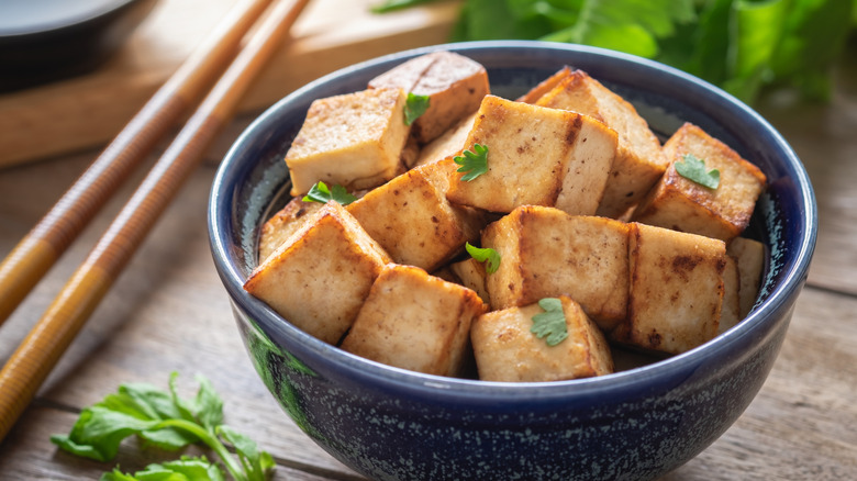 Browned tofu in blue bowl