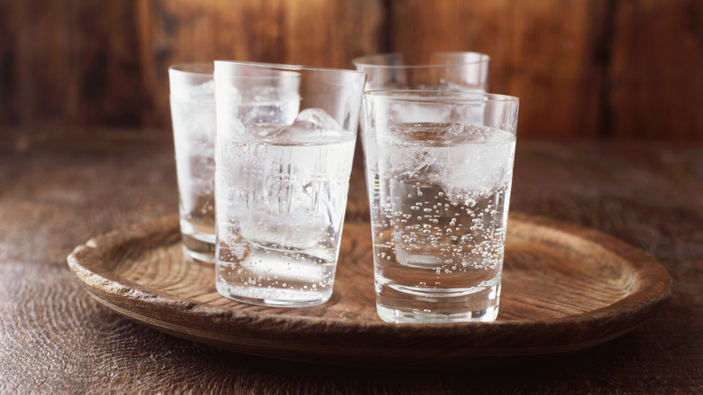 Serving tray topped with glasses of club soda