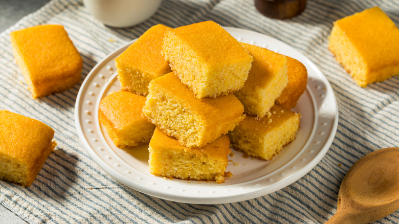 cornbread squares stacked on a white plate