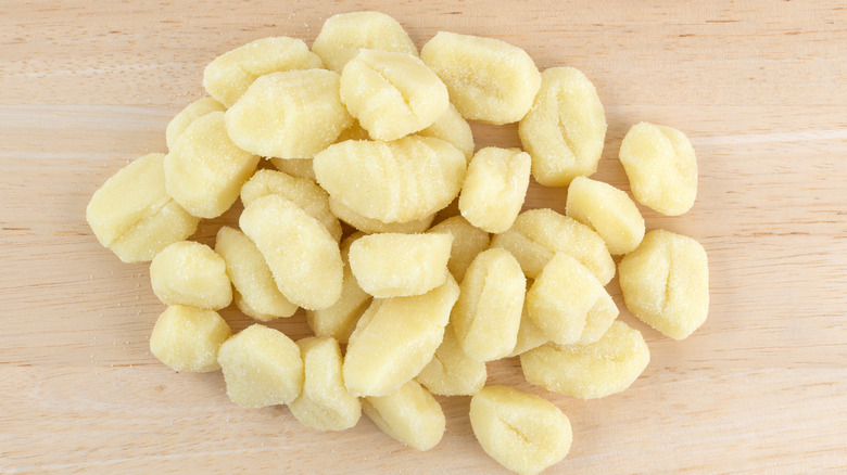 Frozen potato gnocchi on wood table