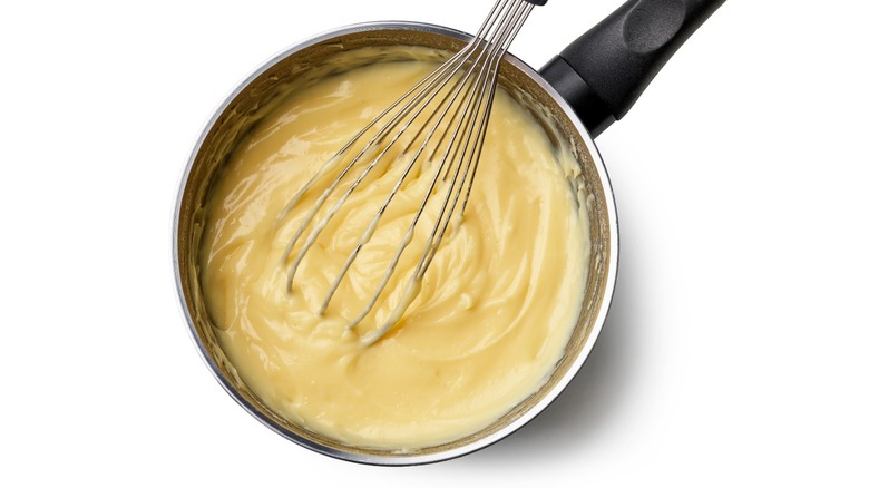 Custard being stirred in pot.