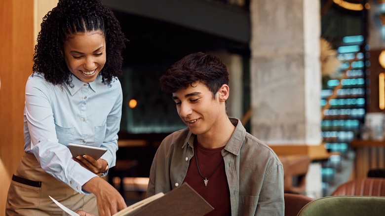 People reading a restaurant menu