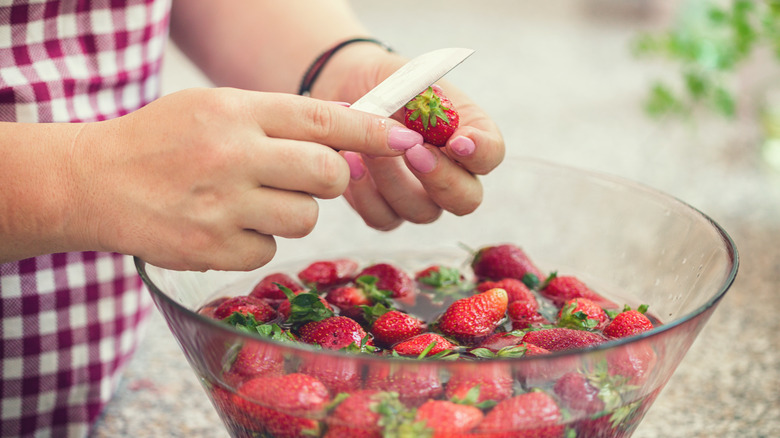 Preparing strawberries to be washed