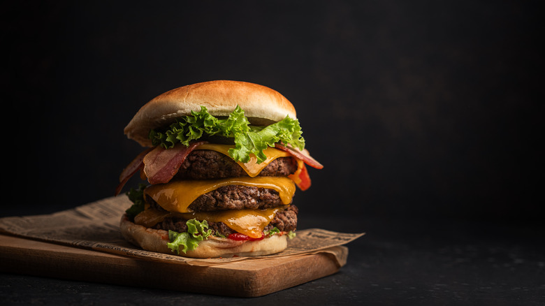 Triple decker burger on a plank