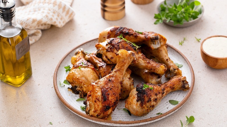 Golden-brown drumsticks garnished with fresh herbs