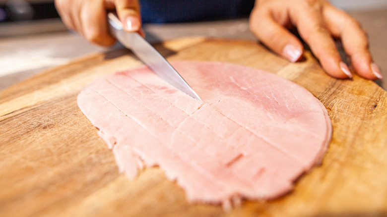 butcher cutting ham steak