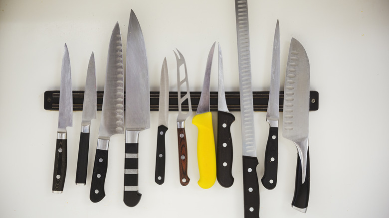 Knives arranged on a magnetic knife strip