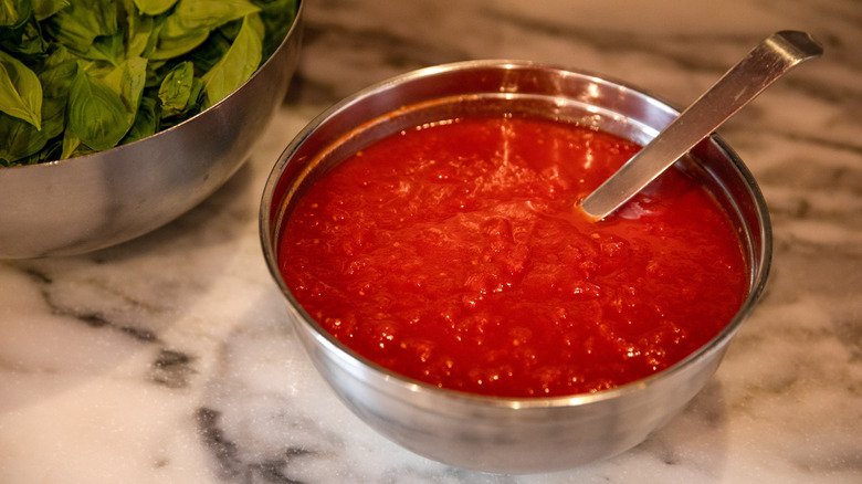 silver bowl of tomato sauce