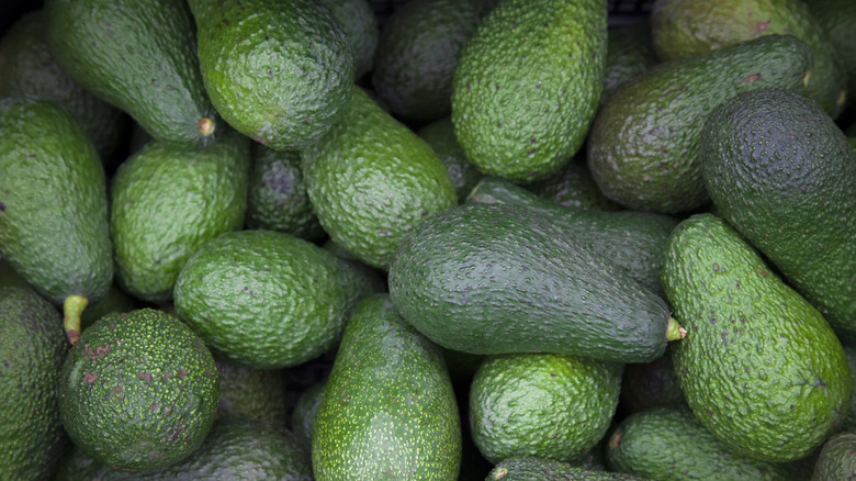 Overhead view of a pile of avocados