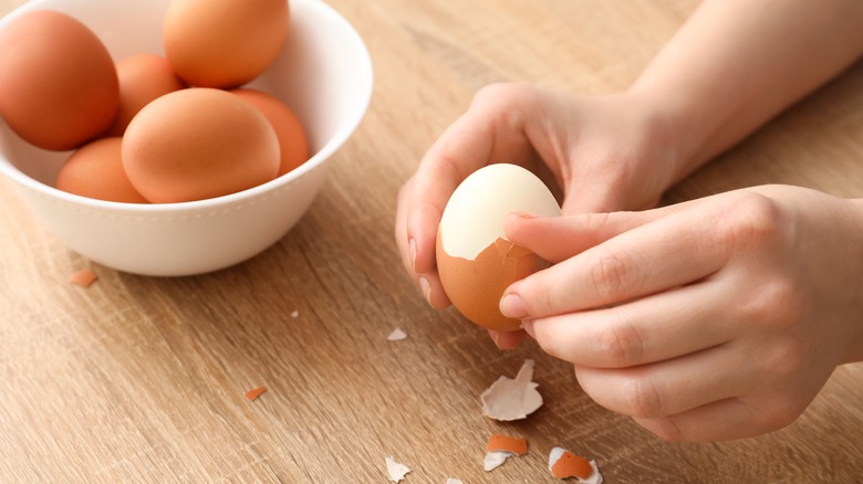 hard-boiled egg being peeled