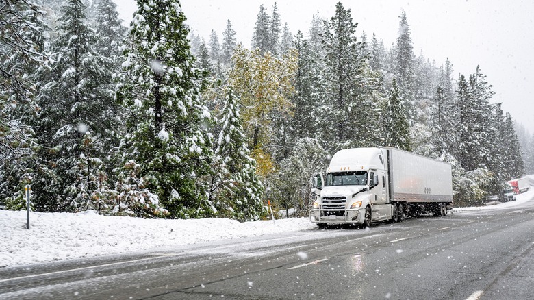Tractor trailer on snowy road 