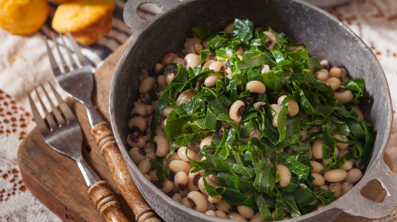 A pot of black-eyed peas garnished with collard greens