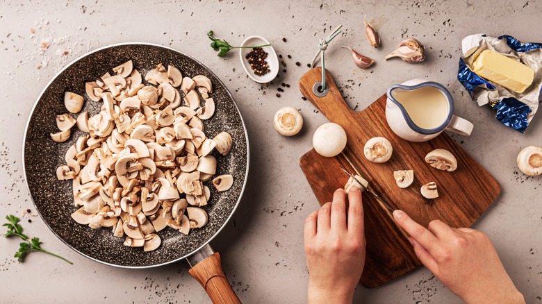 Person preparing to cook mushrooms