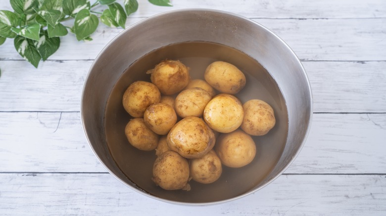 Potatoes soaking in water pot