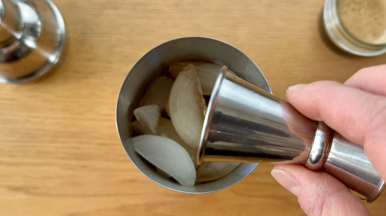 Pouring spirits into cocktail shaker