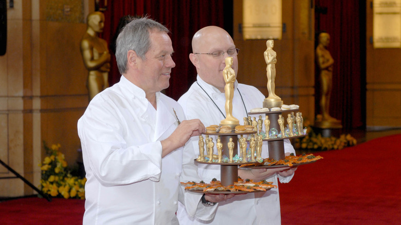 Celebrity chef Wolfgang Puck passes out chocolates at the Oscars