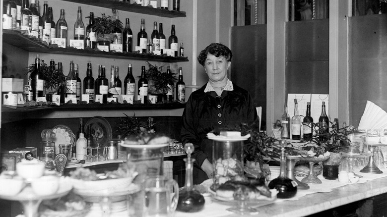 Vintage photo of woman standing behind bar