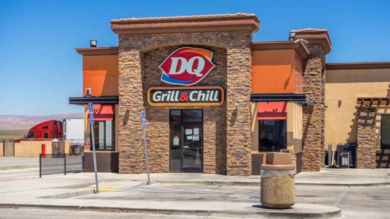 a Dairy Queen store with a background of hilly desert