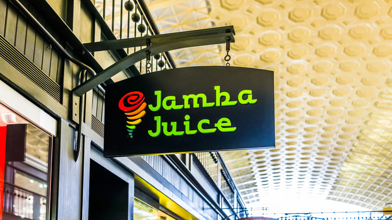 a Jamba Juice sign hanging outside a storefront under an awning