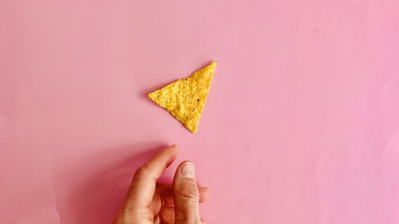 Tortilla chip and hand