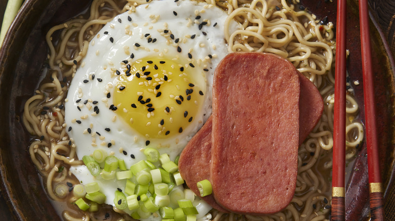 A bowl of ramen with a fried egg and Spam slices