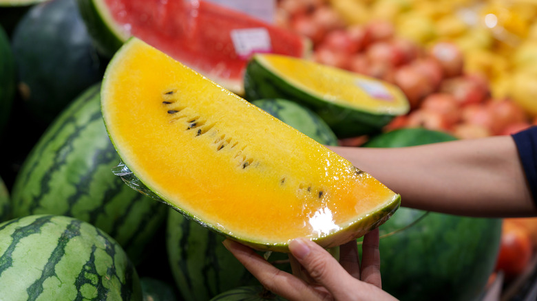 Halved yellow watermelon at store