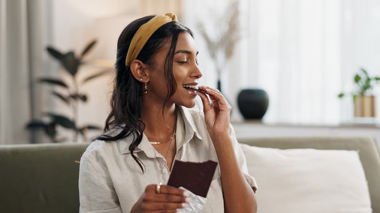 Woman eating a chocolate bar