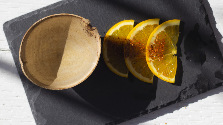 Mezcal with orange slices and worm salt 