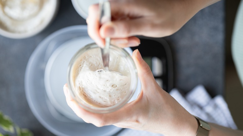 woman mixing a sourdough starter