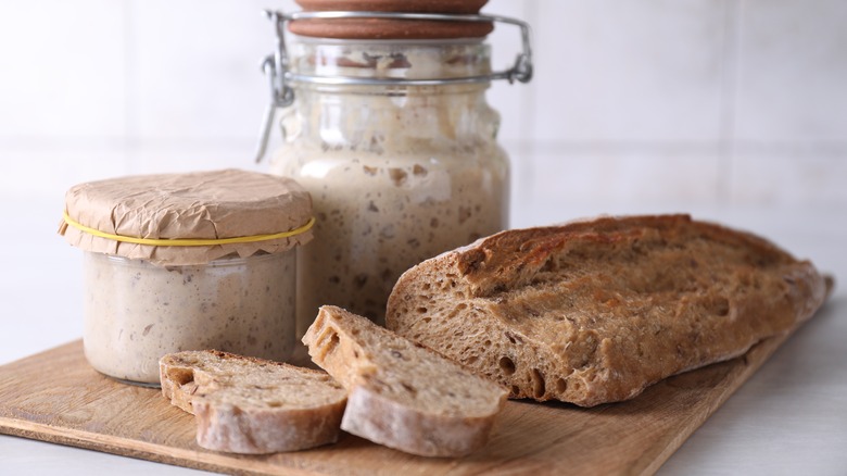 sourdough starters next to a load of bread