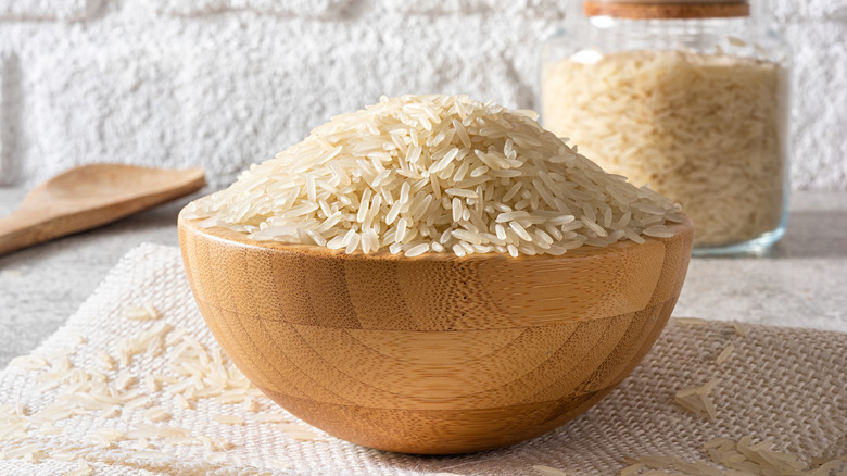 uncooked rice in a wooden bowl