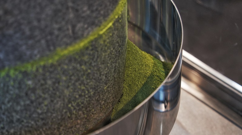 close up of stone mill grinding matcha