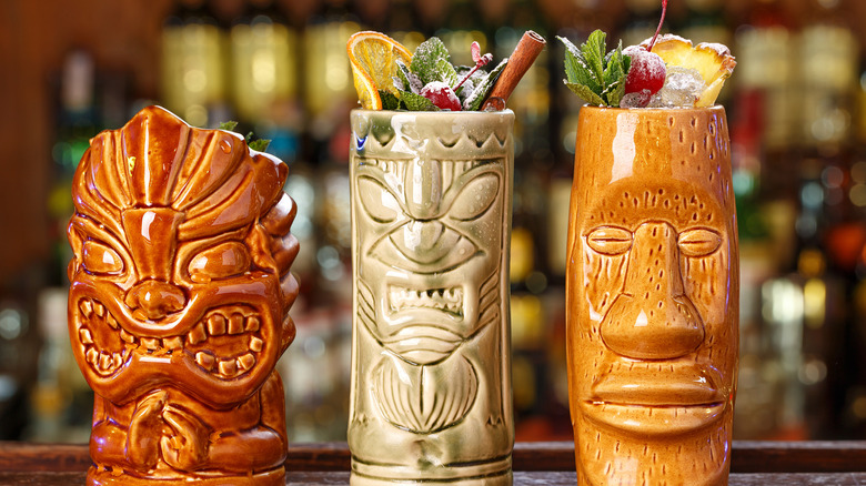 row of Tiki drinks on a bar