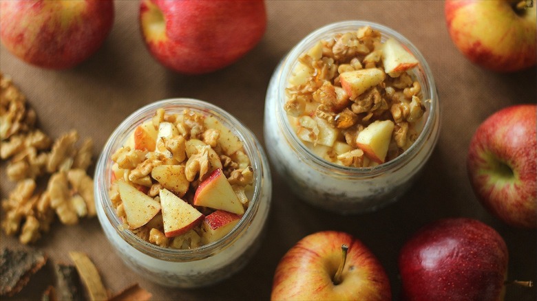 Oatmeal in mason jars with walnuts and chopped apples