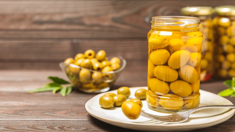 Olives in a jar and on a plate